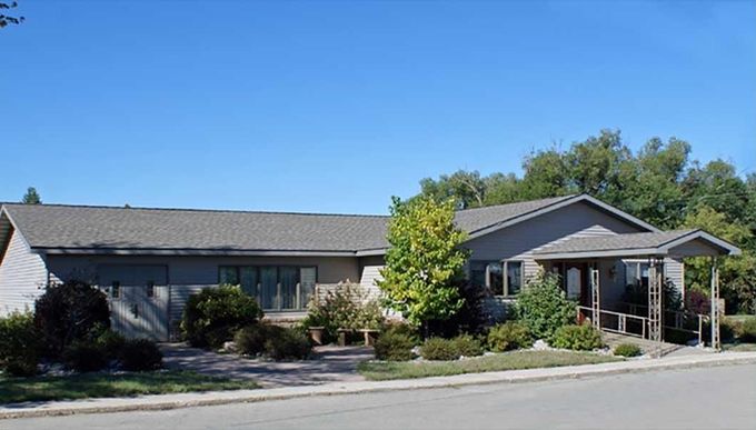 a large house with a large rock in front of it