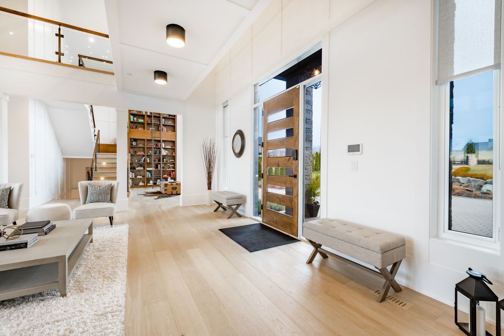 A living room with hardwood floors and a wooden door.