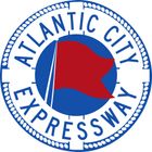 Circular blue and white logo for the Atlantic City Expressway featuring a red flag icon.