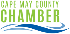 Logo for the Cape May County Chamber of Commerce with green text above a stylized blue wave graphic.