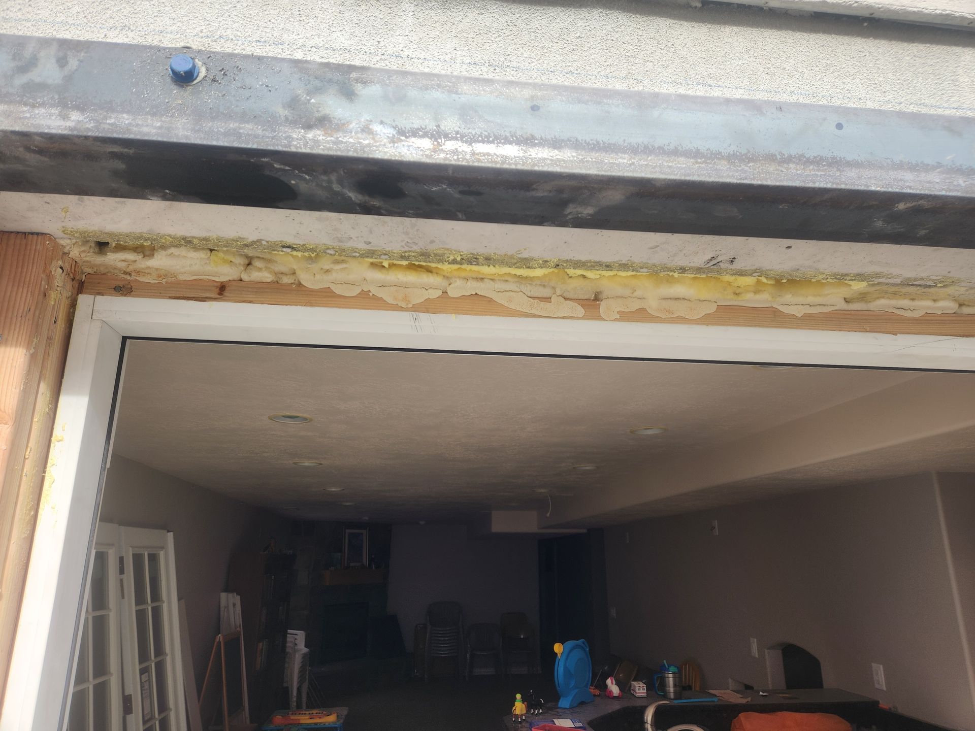 Open garage interior with clutter and a partially finished doorway frame