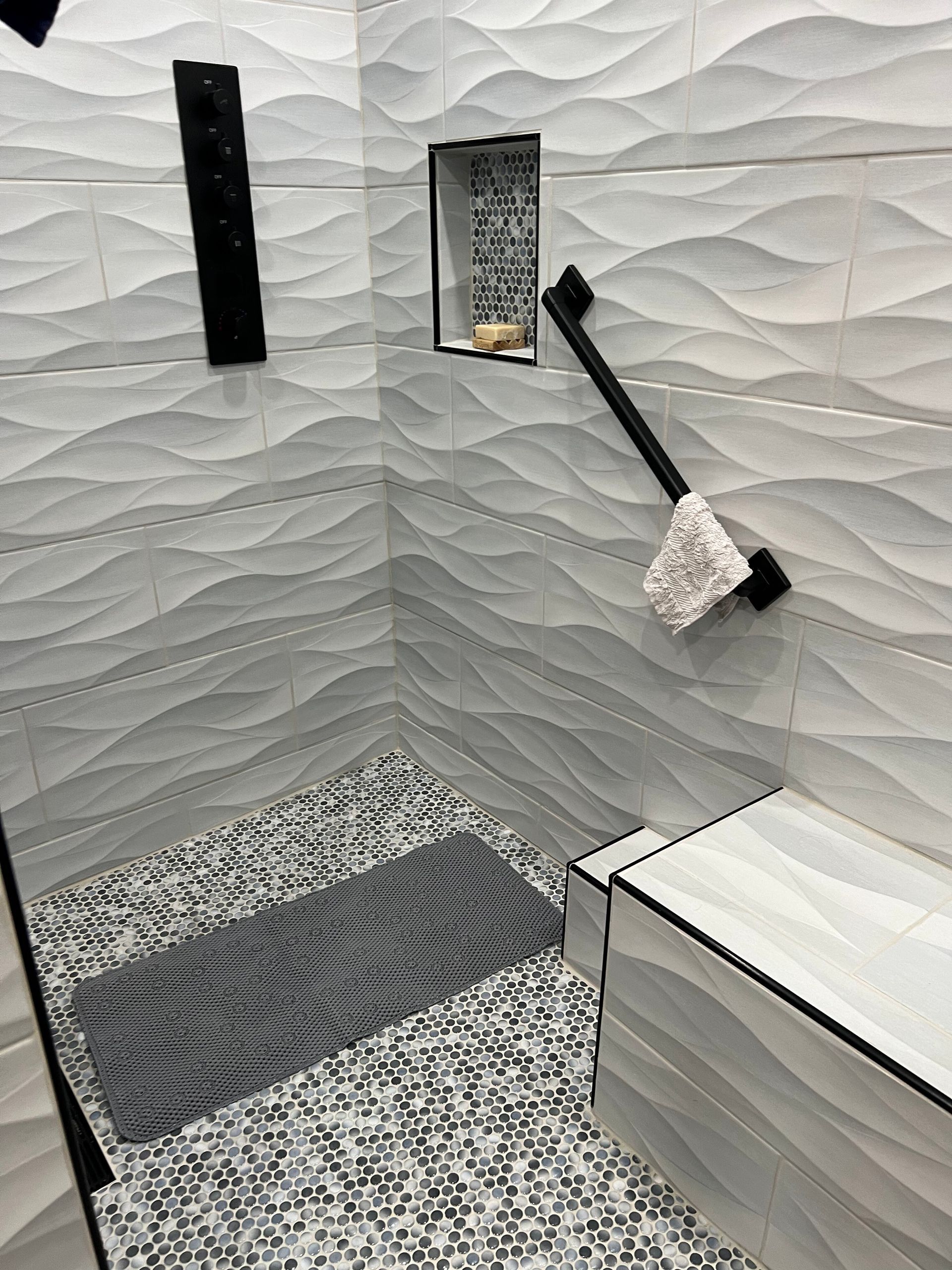 Small textured room with white walls, gray patterned floor, and a white cabinet in the corner.