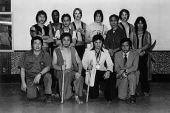A group of people are posing for a picture in a black and white photo.