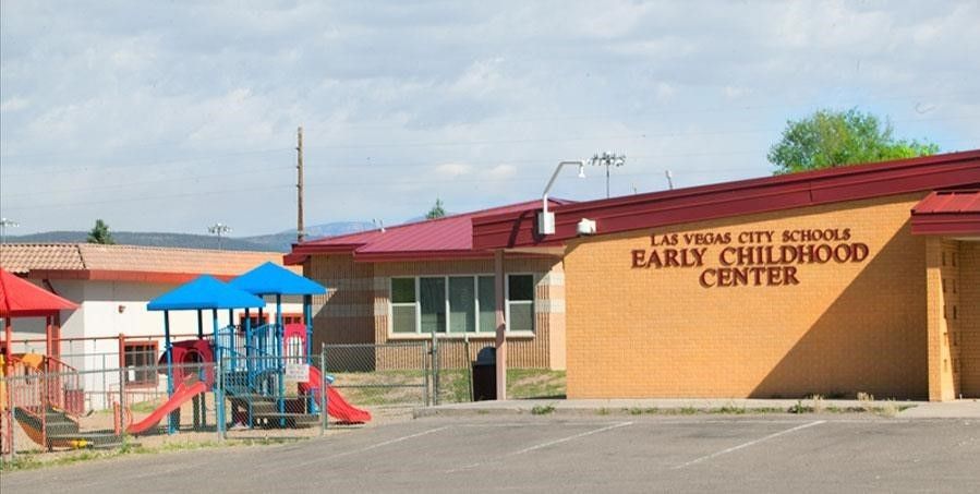 an early childhood center with a playground in front of it