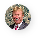 A man in a suit and tie is smiling in a circle.