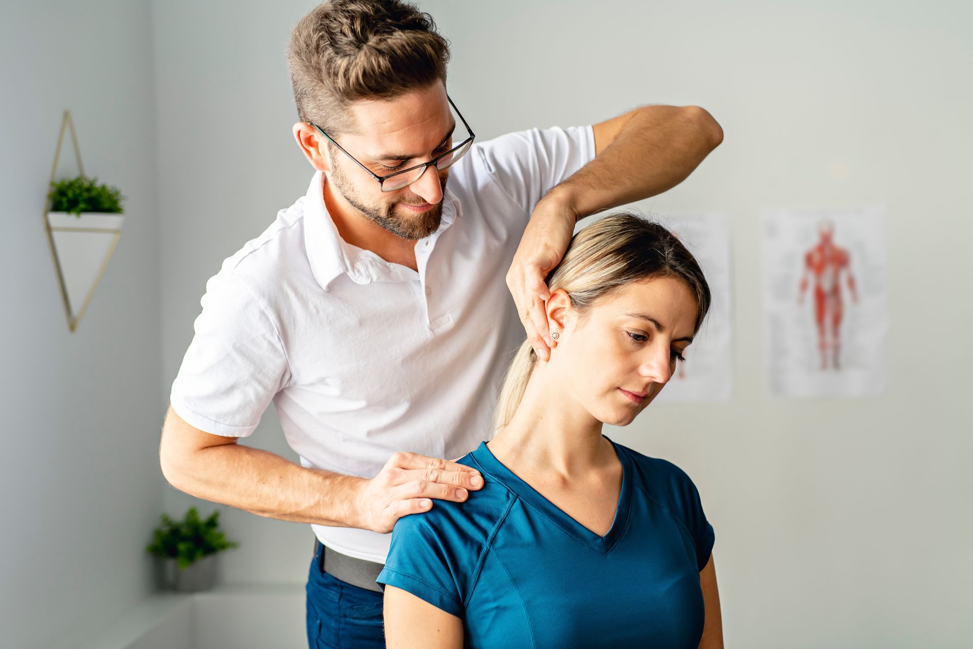 Manual neck and shoulder adjustment performed by a chiropractor in a medical office. Manual neck and shoulder adjustment performed by a chiropractor in a medical office.