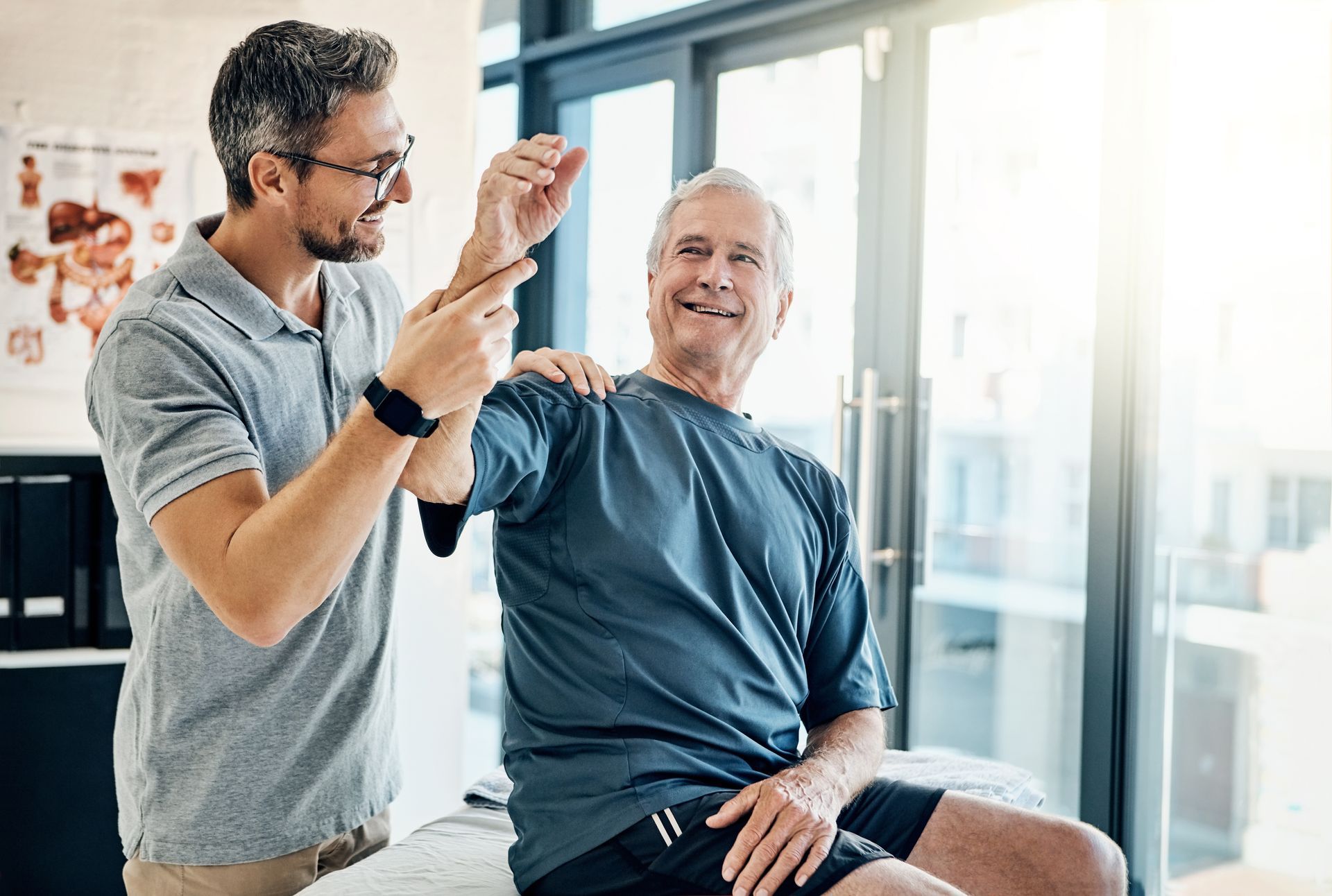 A physical therapist assisting an elderly man with arm exercises in a bright rehabilitation room. A physical therapist assisting an elderly man with arm exercises in a bright rehabilitation room.