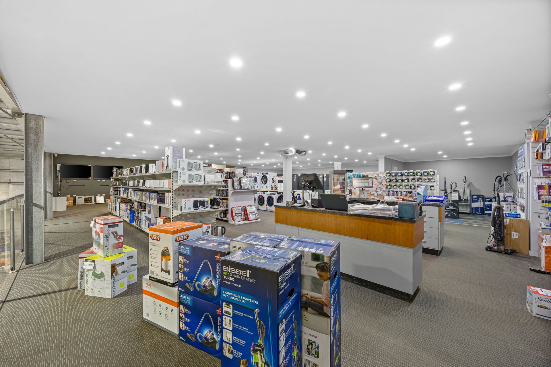A store filled with lots of appliances and a counter.
