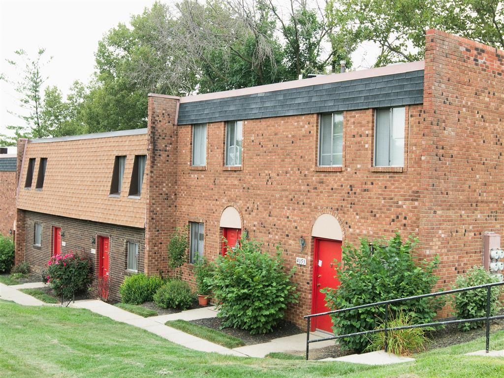 Brick apartment building exterior with red doors and landscaping at Shadow Hill, offering pet-friendly apartments near Cincinnati,OH.