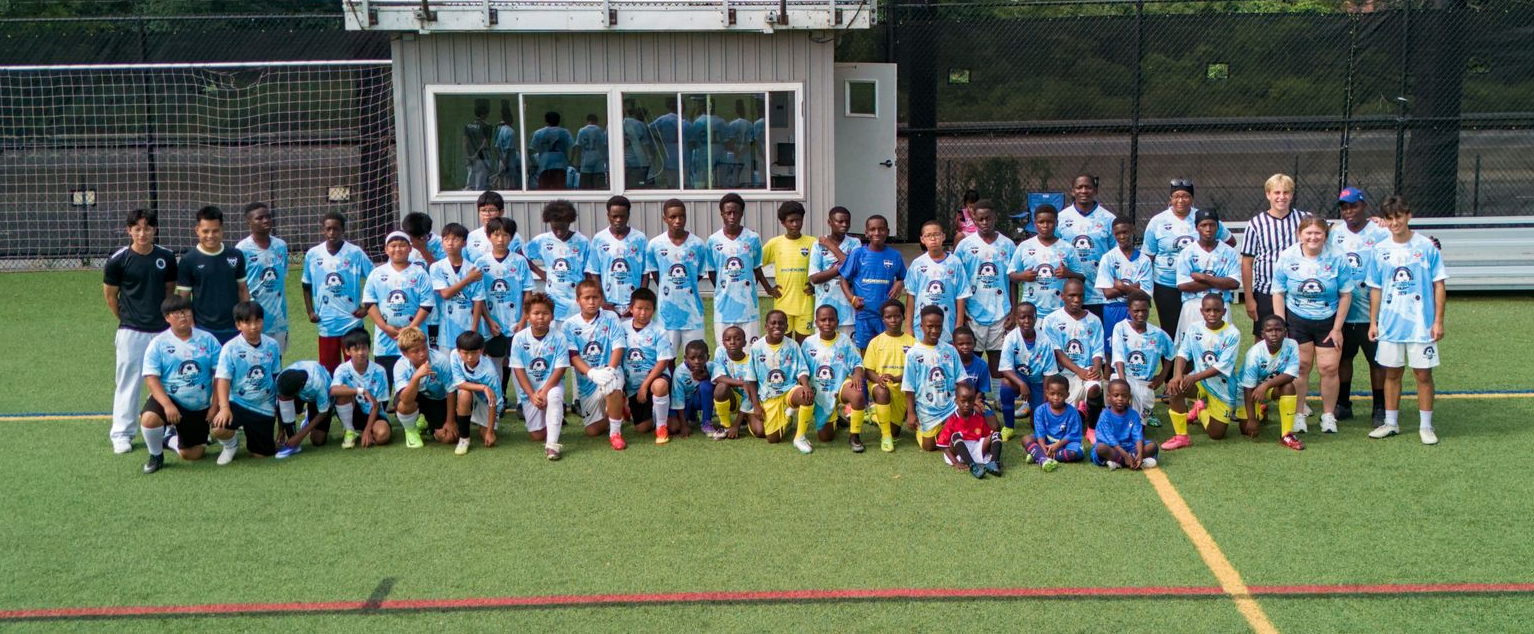 Large group of players in yellow and blue jerseys lined up on a soccer field after a match