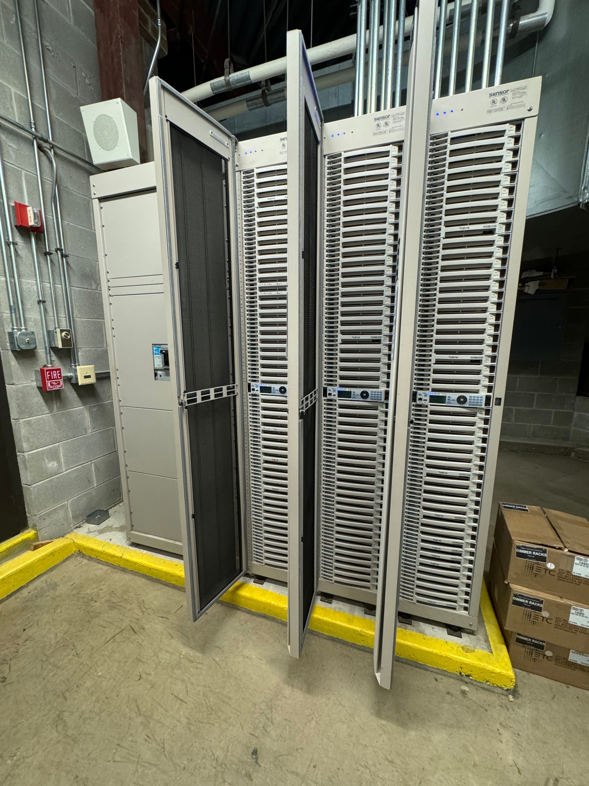 A row of metal cabinets are sitting next to each other in a room.