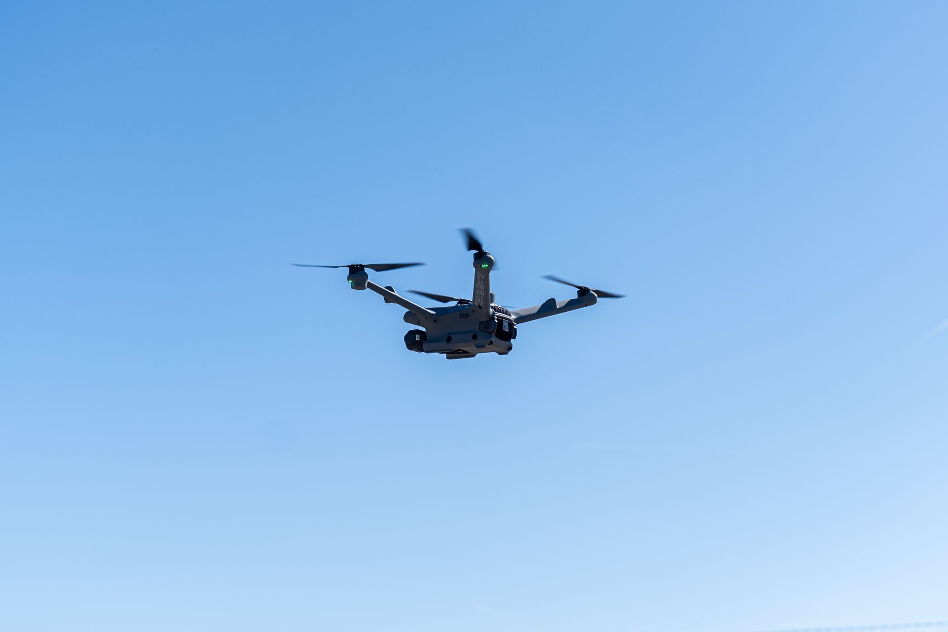 drone hivering in blue sky over runway 