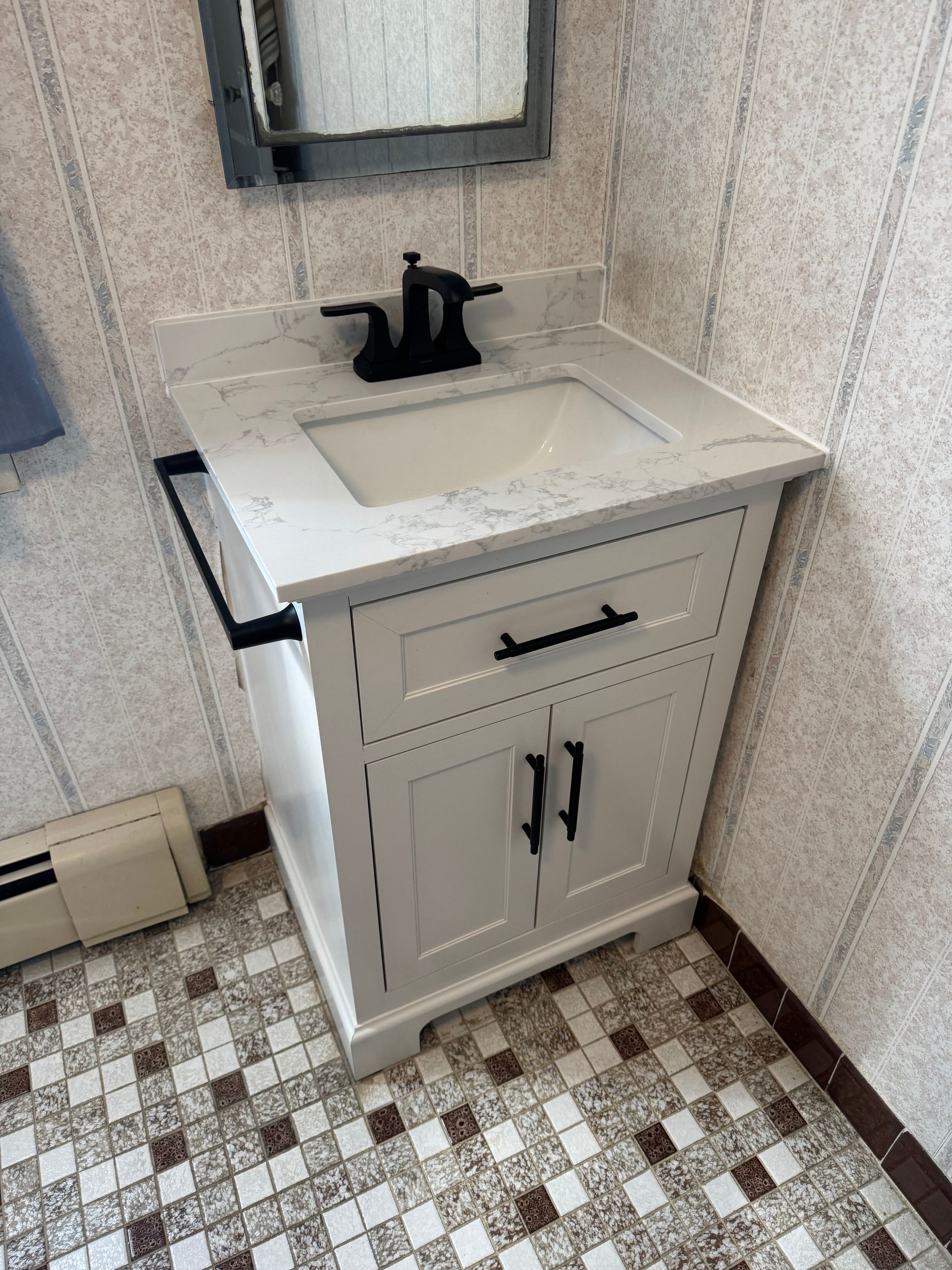 A bathroom vanity with a sink and a mirror.