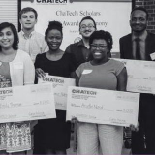 A group of people holding checks that say chatech