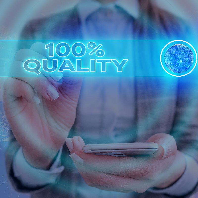 A person holding a cell phone in front of a screen that says 100 % quality
