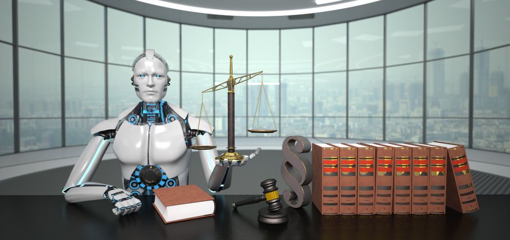 A robot is sitting at a desk with a book , scales of justice , and a gavel.
