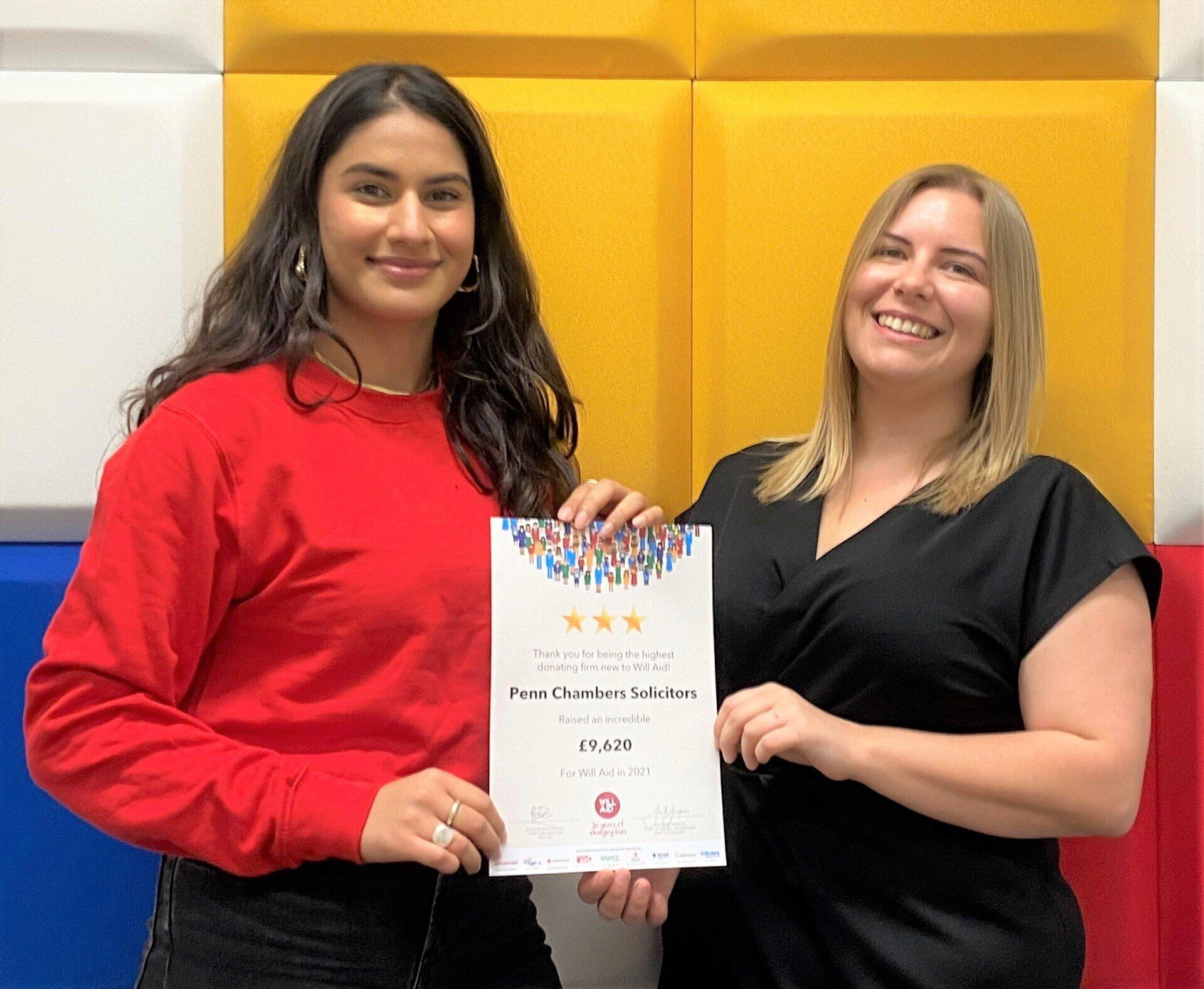 Two women are standing next to each other holding a certificate.