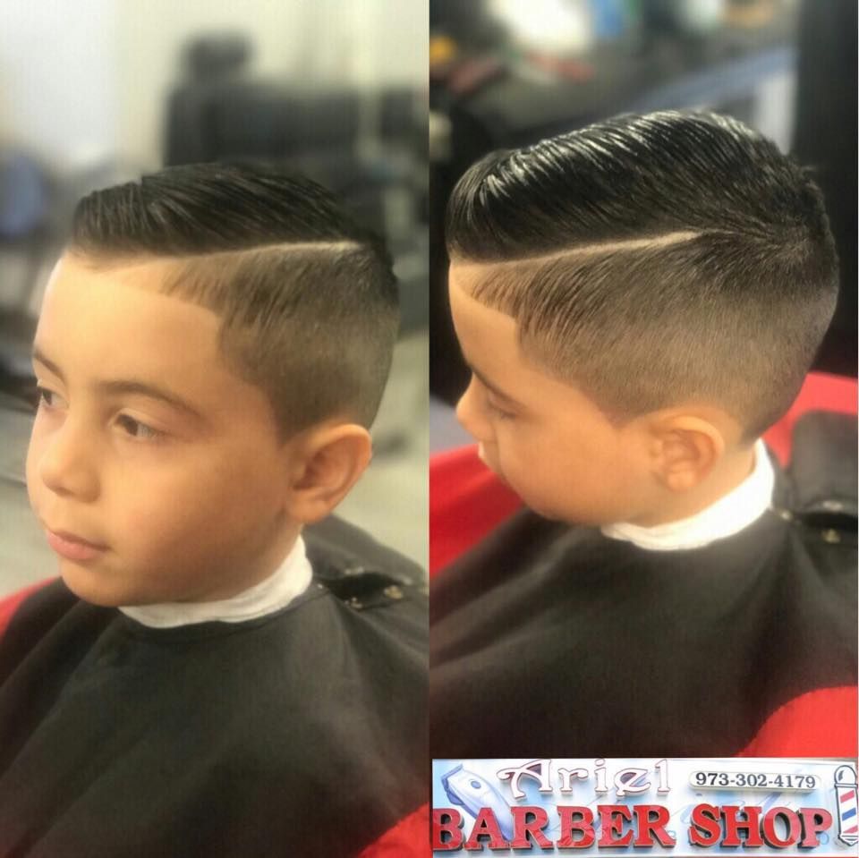 Boy with a slick side-part haircut shown from front and side in a barber shop cape