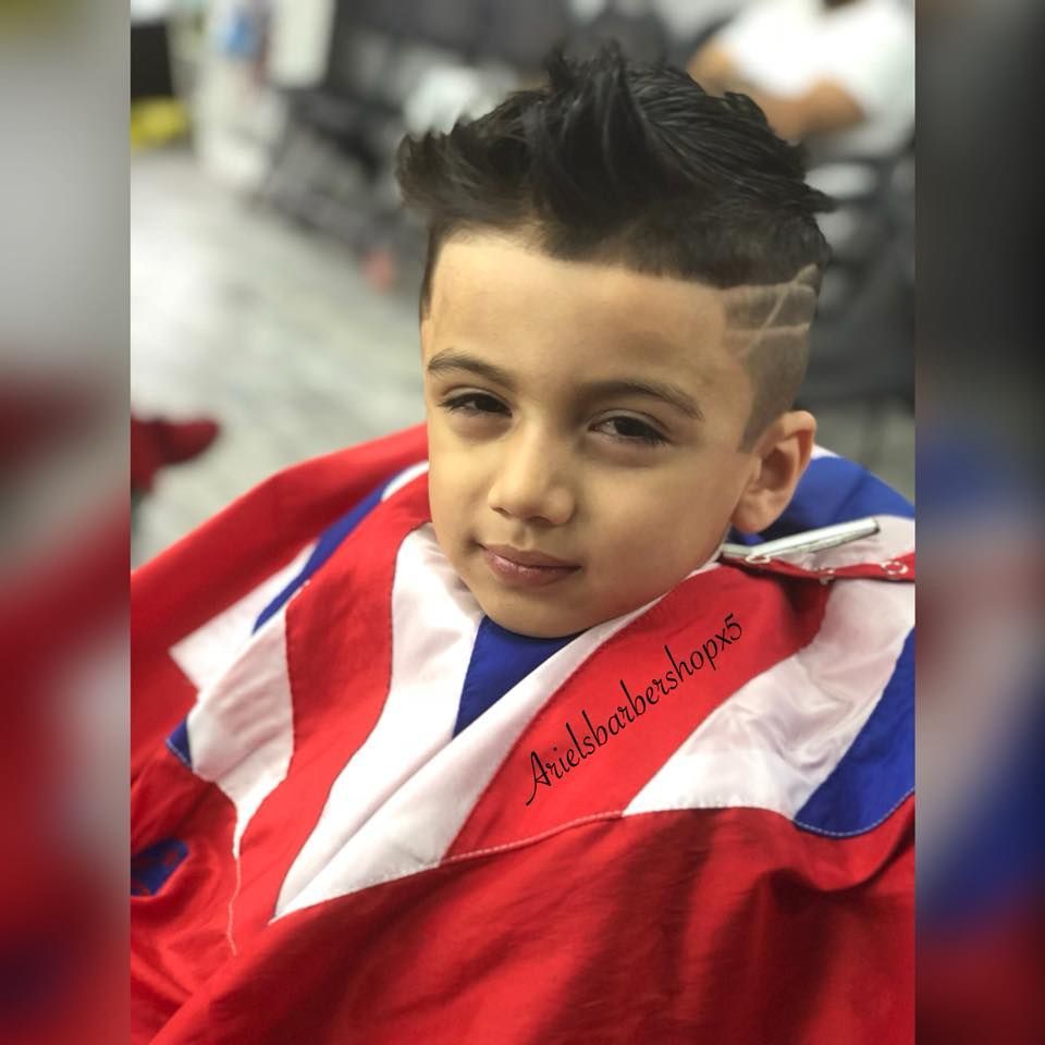 Child wrapped in a red, white, and blue flag, posing with a slight smile