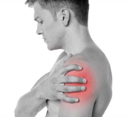 A person clutching their shoulder in pain, with a red overlay indicating the area of discomfort.