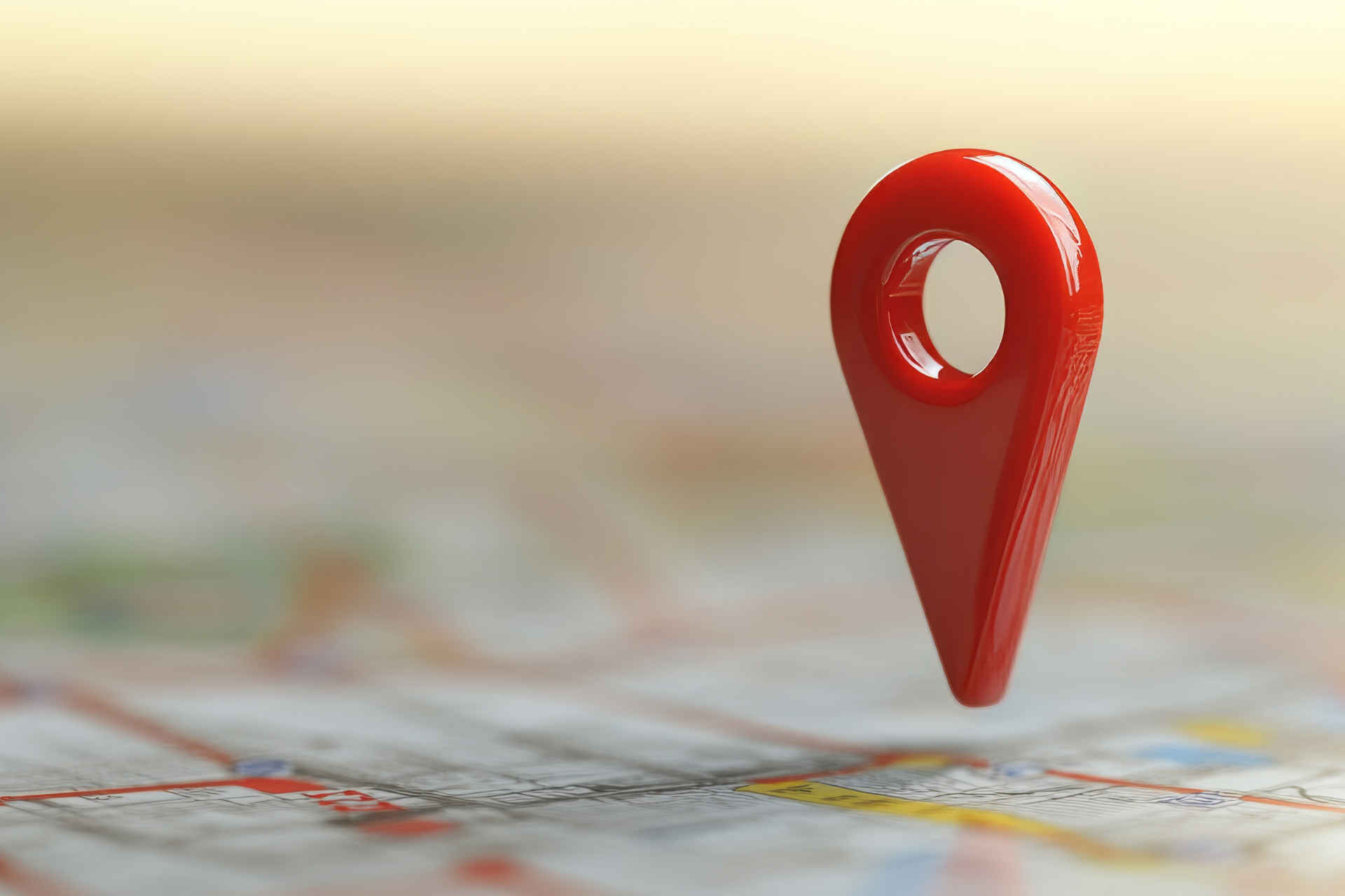 A red map pin is sitting on top of a map.