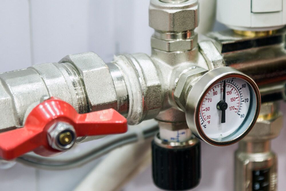 A Close Up of a Valve and a Pressure Gauge on a Pipe — Daniel Gray Plumbing in Kingscliff, NSW
