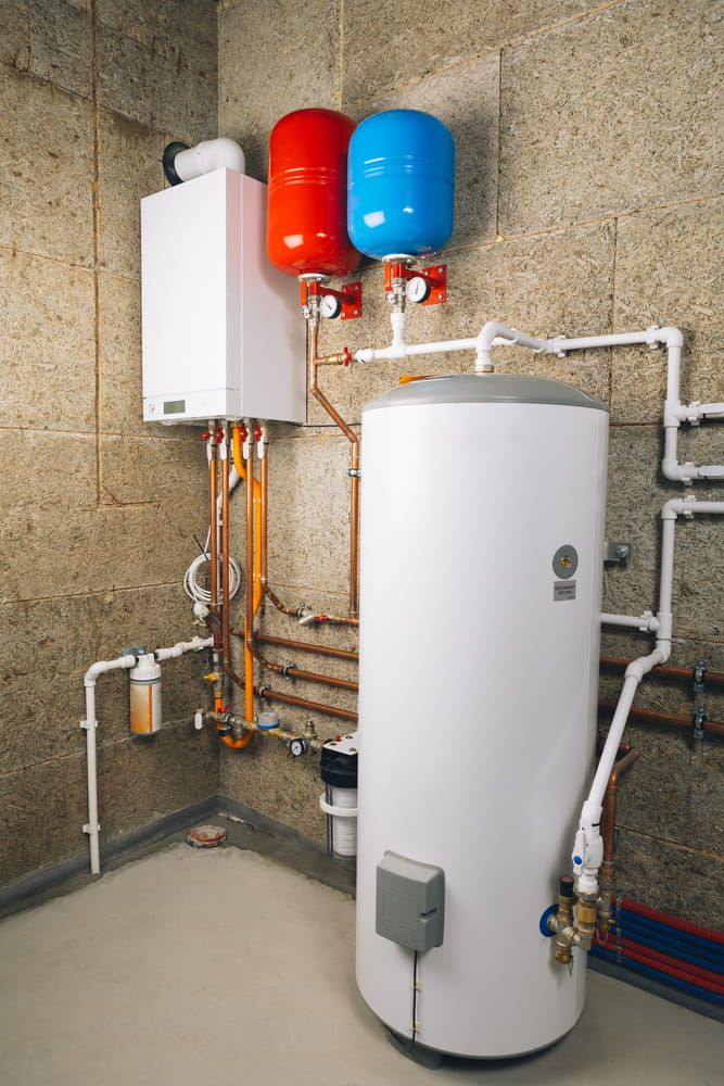 A Water Heater is Sitting in a Room Next to a Boiler — Daniel Gray Plumbing in Kingscliff, NSW