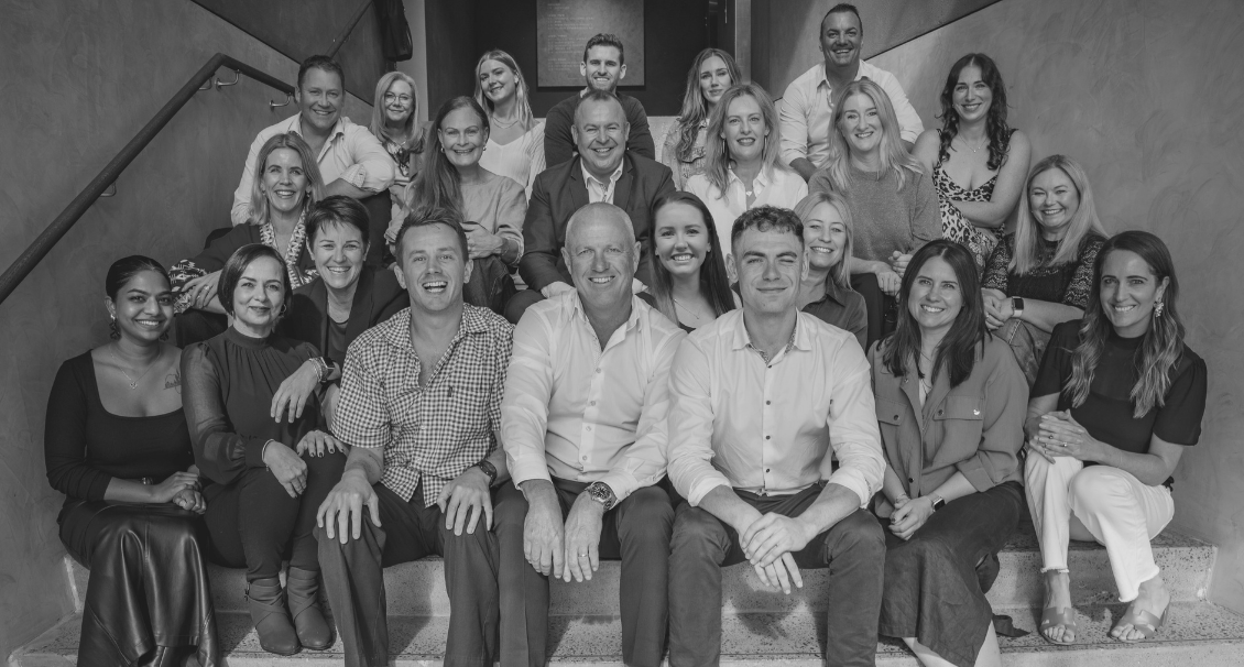 Black and white photo of Alexander James team in stairwell
