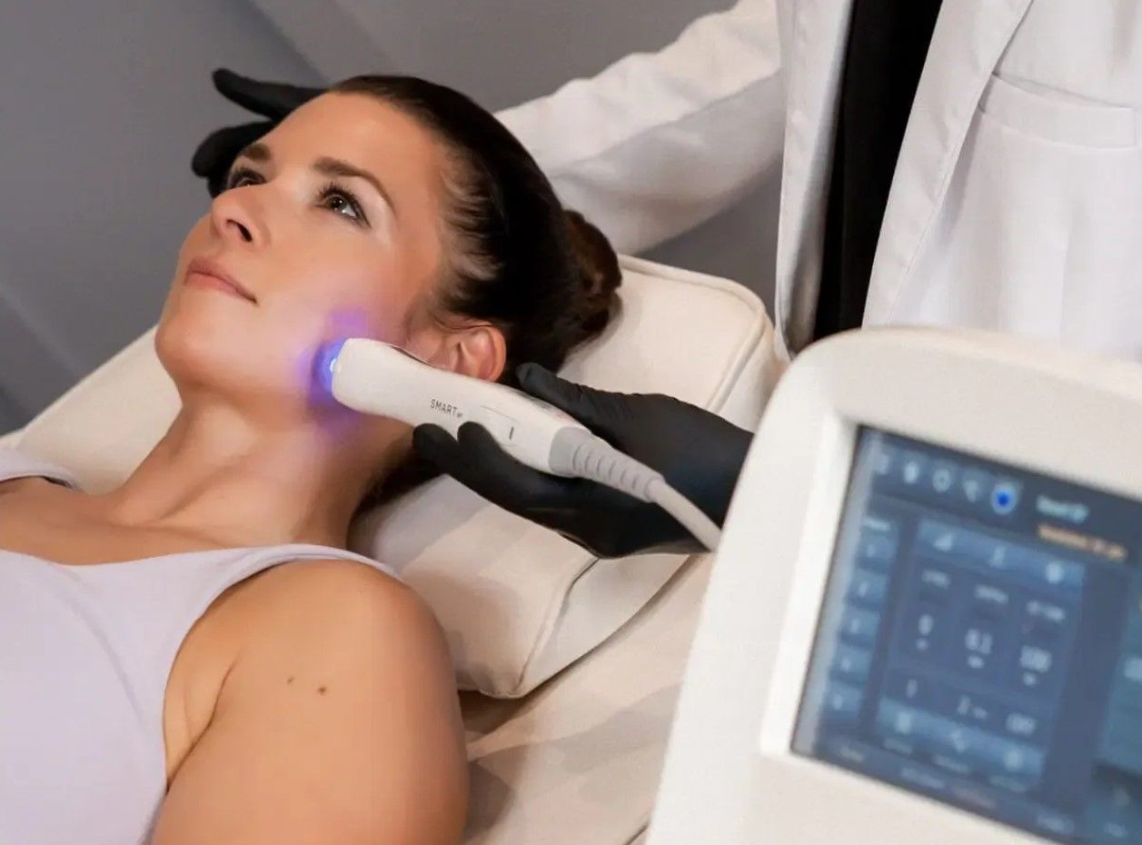 A woman is getting a facial massage at a spa.