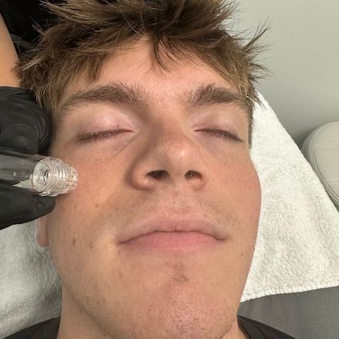 A man is getting a facial treatment at a spa.