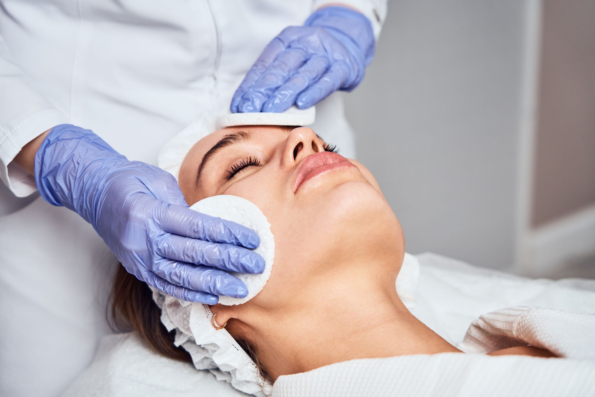 A woman is getting a facial treatment at a beauty salon.