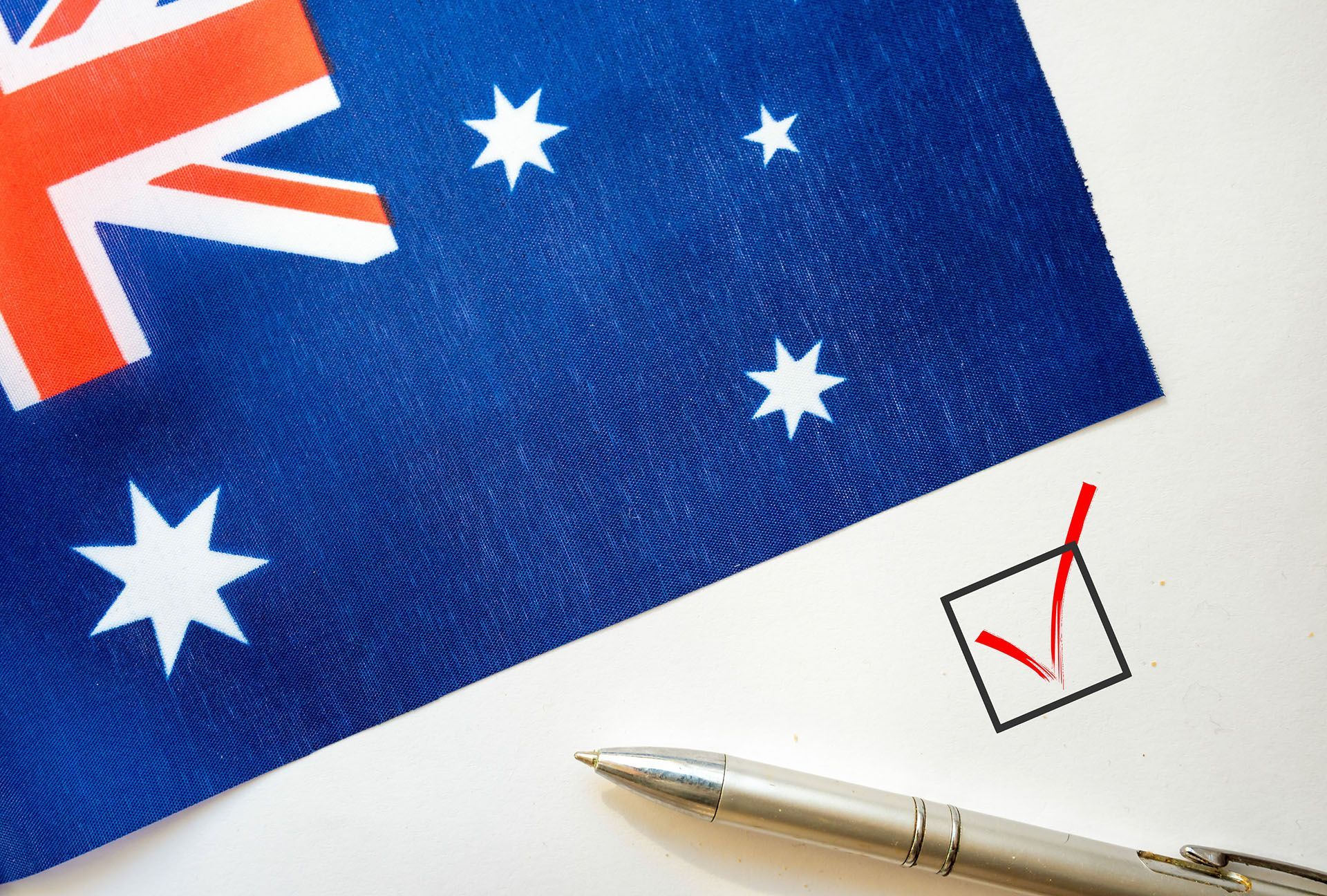a pen is sitting on a piece of paper next to the Australian flag