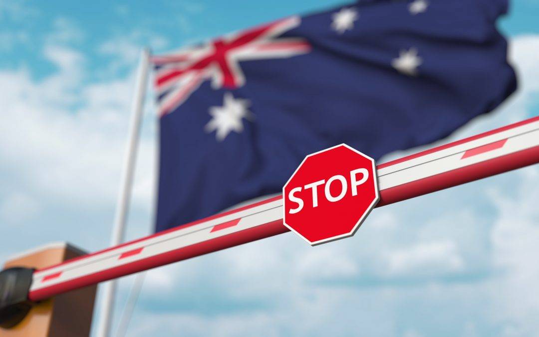 a stop sign is behind a barrier with a flag in the background