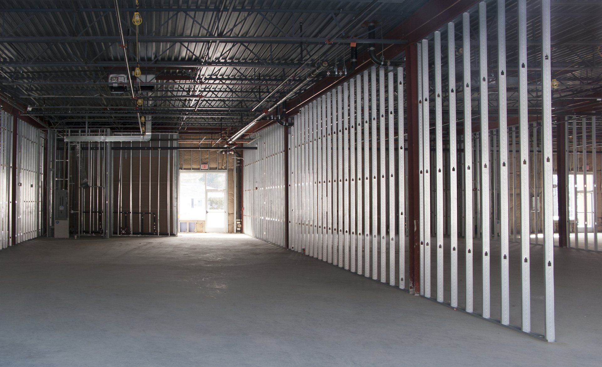 A large empty commercial space with metal walls and a ceiling.
