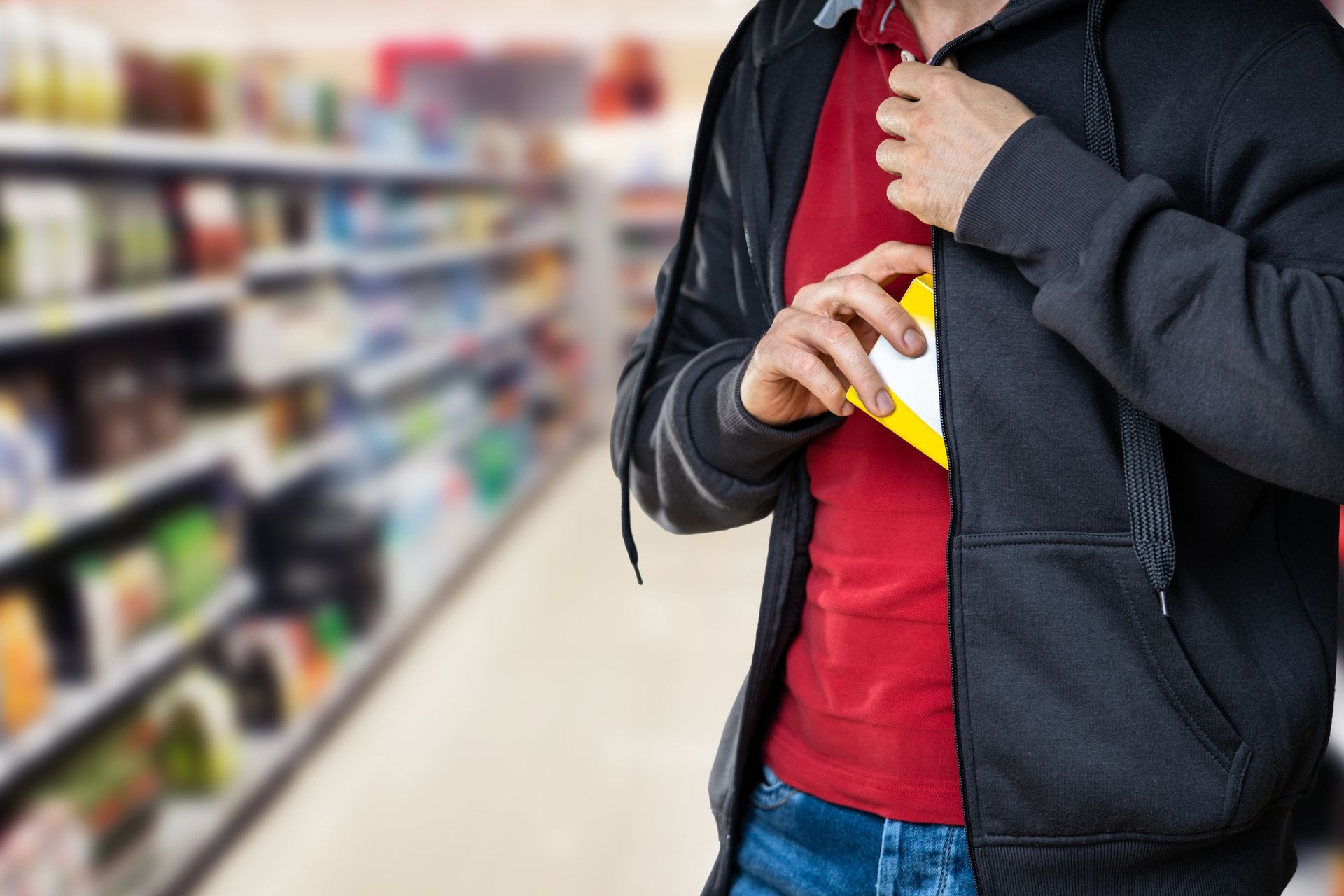 A man is taking something out of his pocket in a store.