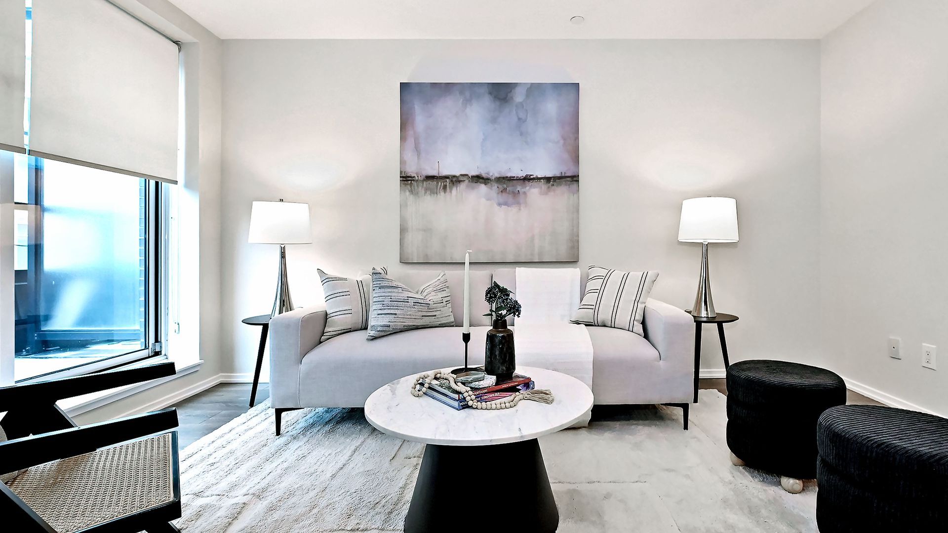 Modern open-concept living room with white sectional, kitchen, and sliding doors to a patio.
