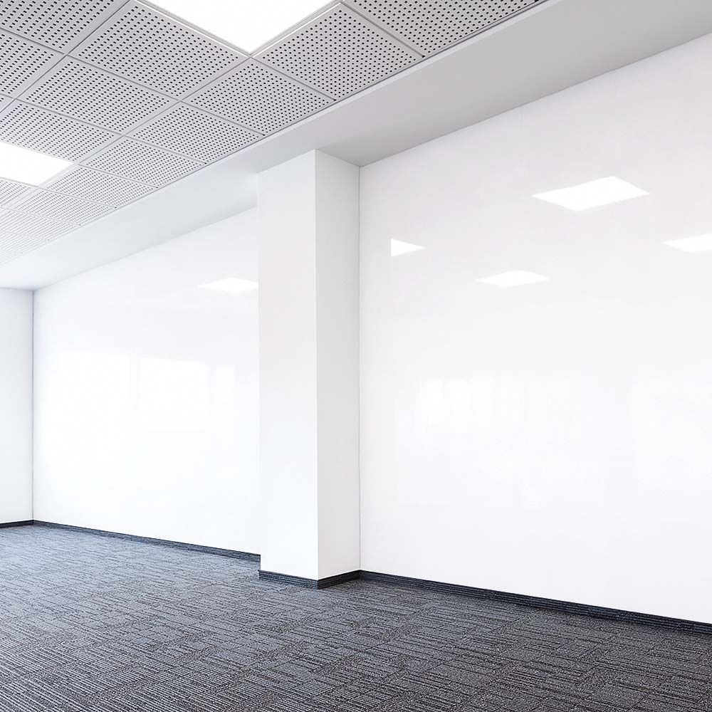 Modern interior wall with high-gloss white dry-erase finish and perforated acoustic ceiling panels