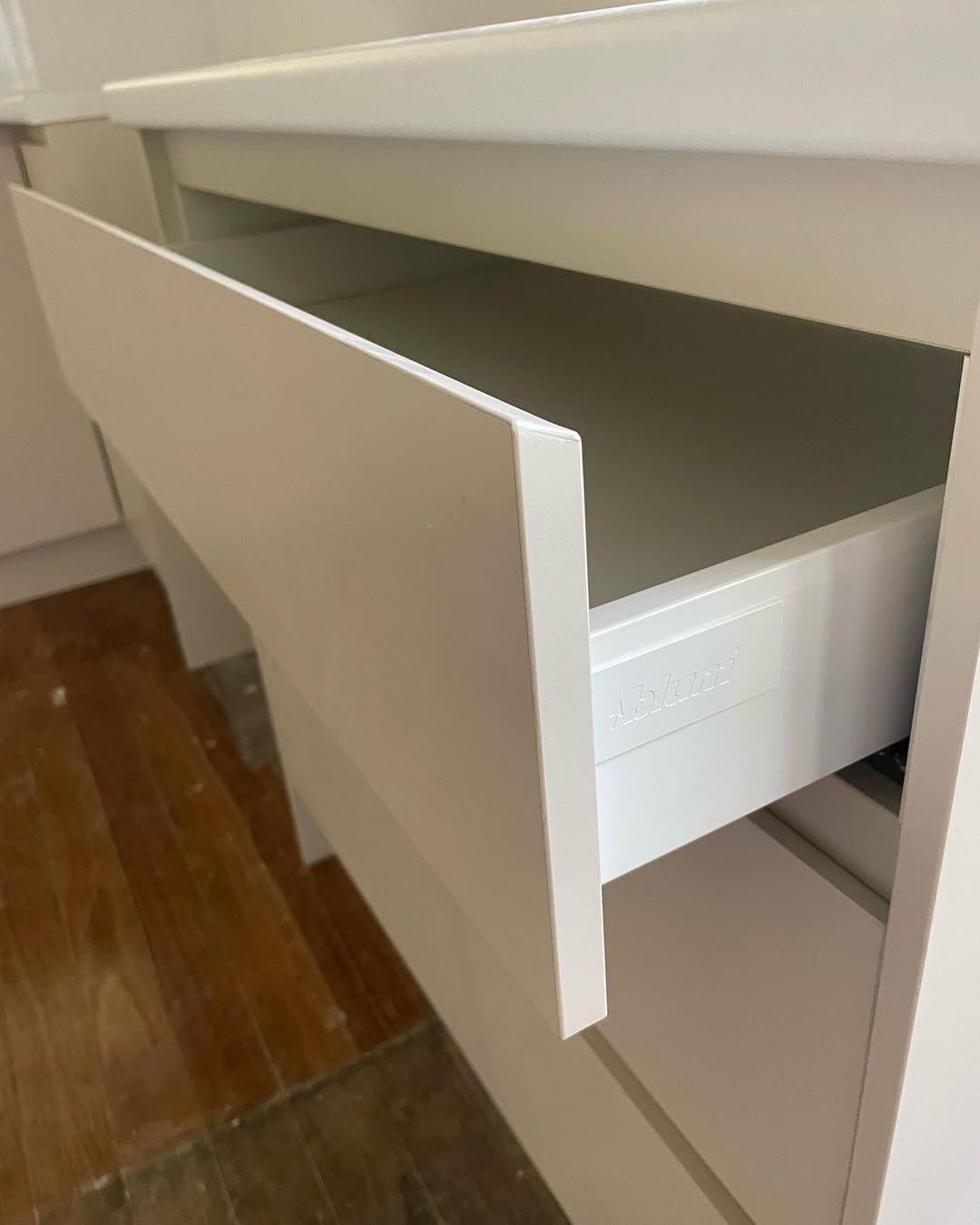 Bathroom vanity with white cabinets, dark gray countertop, and vessel sink. — Maken Kitchens & Cabinets in Chinderah, NSW