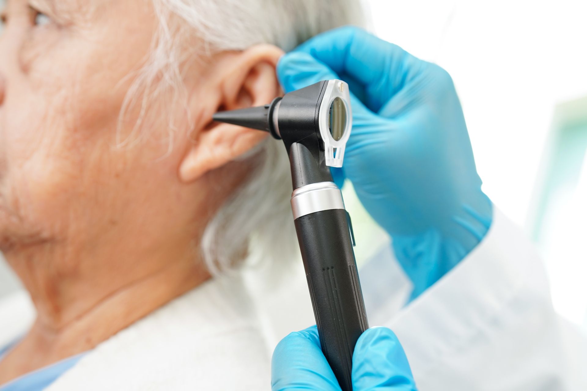 Healthcare professional examining a patient's ear