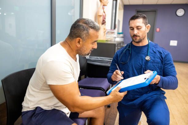 A male nurse with a patient needing urgent care injury at West Ocean City Injury & Illness Center near Salisbury, MD.
