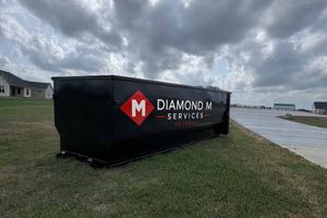 A black dumpster branded with a 