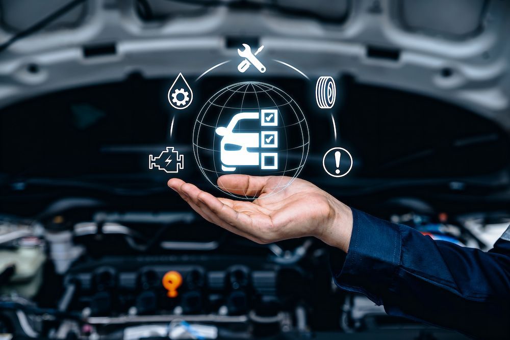 A Person Is Holding A Car Engine — Hunter Automotive In Innisfail, QLD