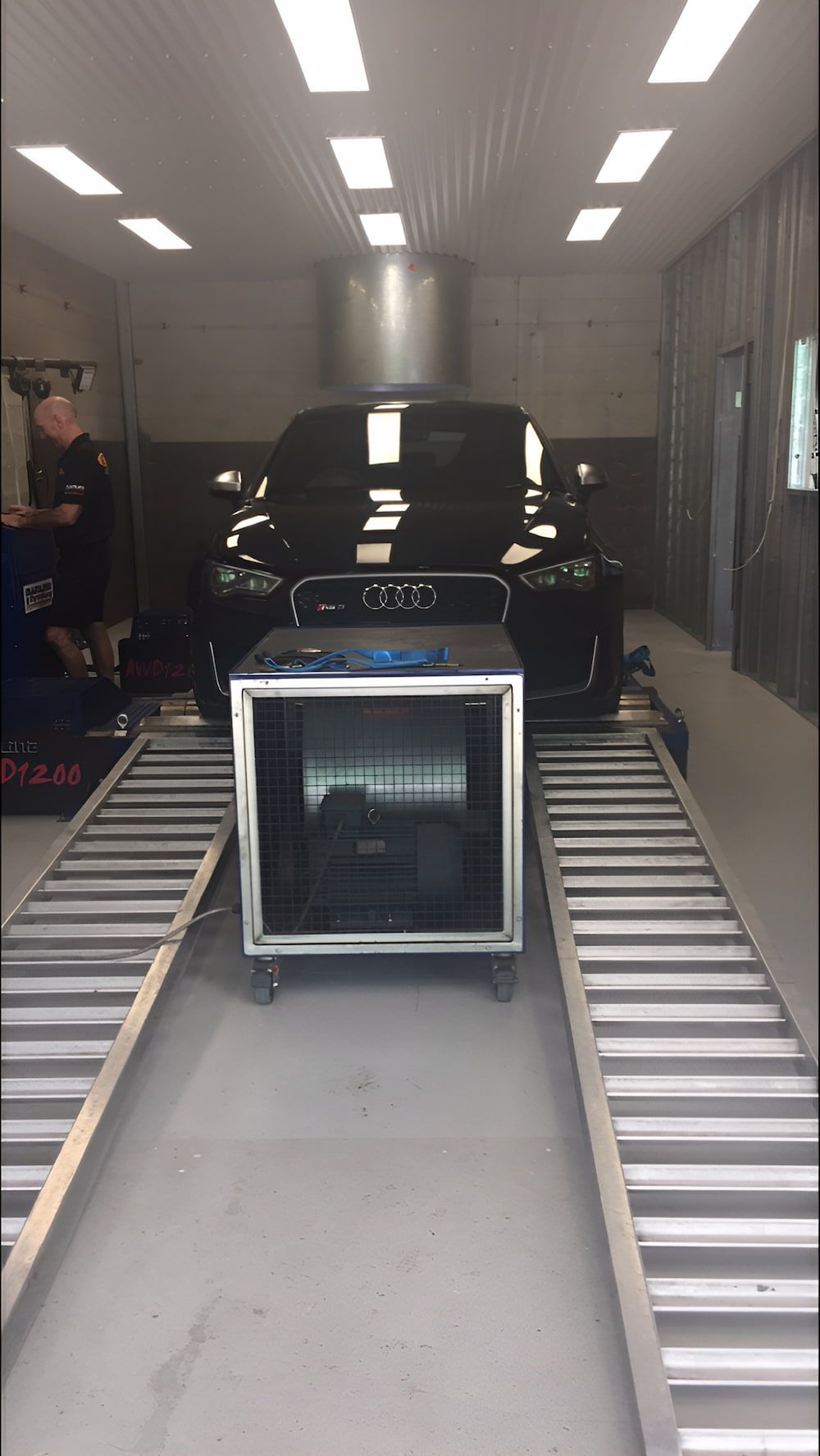 A Car Is Sitting On A Conveyor Belt In A Garage — Hunter Automotive In Bungalow, QLD