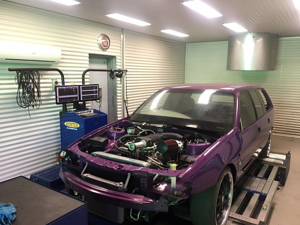 A Purple Car Is Sitting In A Garage With Its Hood Open — Hunter Automotive In Bungalow, QLD