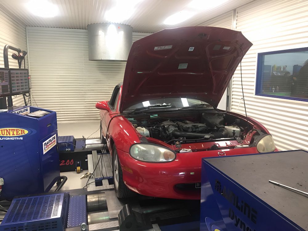 A Red Car With Its Hood Up Is Being Tested In A Garage — Hunter Automotive In Bungalow, QLD