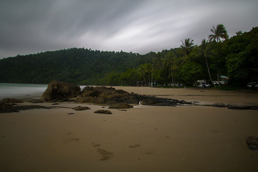 A Beach With Palm Trees And Mountains In Innisfail — Hunter Automotive In Innisfail, QLD
