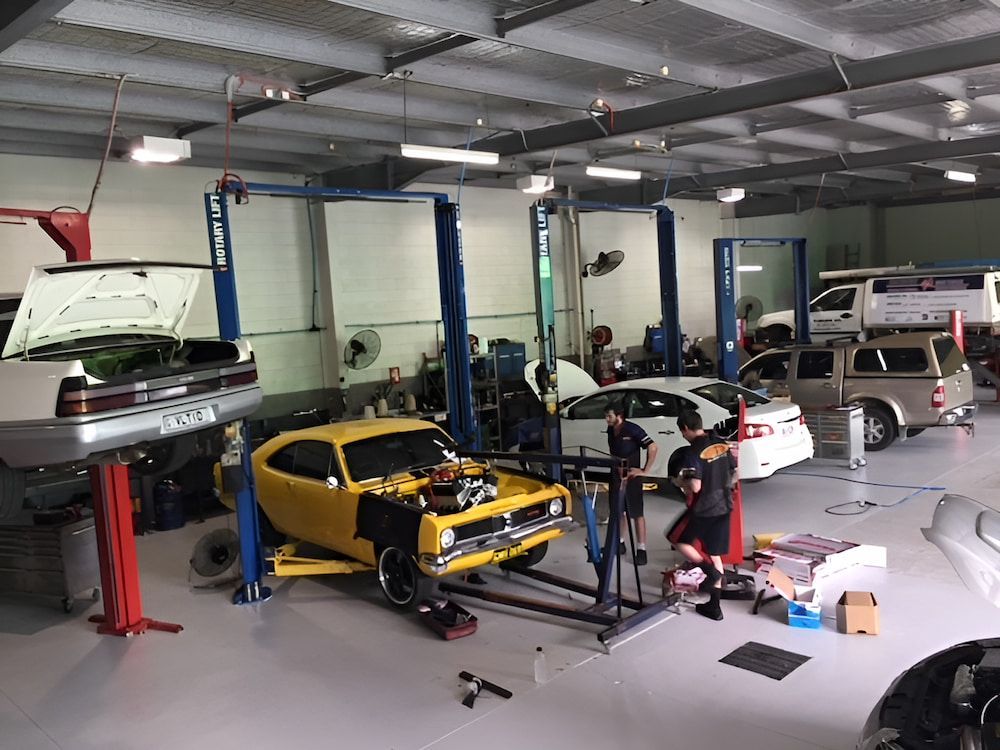A Yellow Car Is Being Worked On In A Garage — Hunter Automotive In Bungalow, QLD