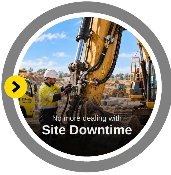 Hydraulink technician repairing excavator hydraulics on a construction site