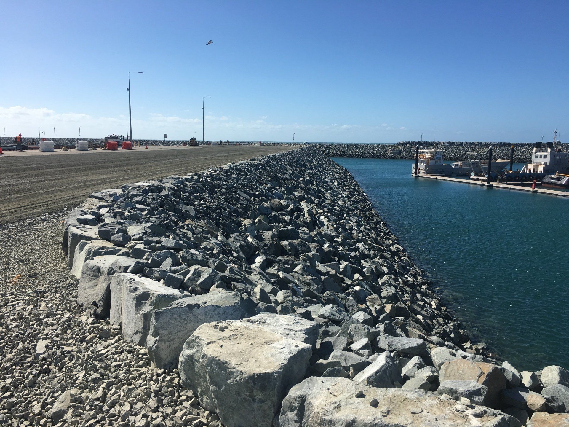 Rocky Breakwater Extends Into a Harbor Under a Clear, Blue Sky — CJD Investments (NQ) Pty Ltd in Mackay Harbour, QLD