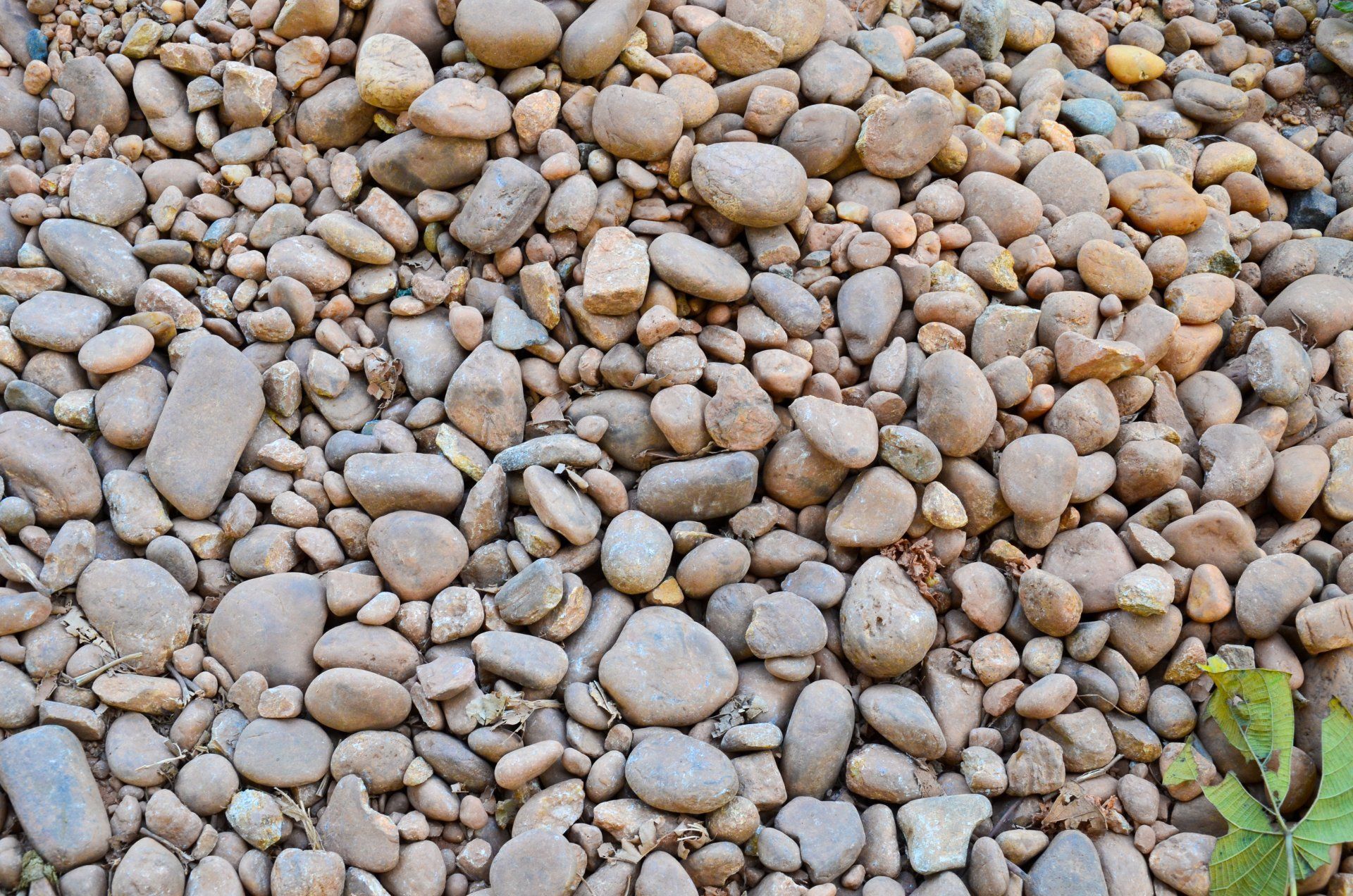 Brown, Smooth River Rocks Tightly Packed Together — CJD Investments (NQ) Pty Ltd in Mackay Harbour, QLD